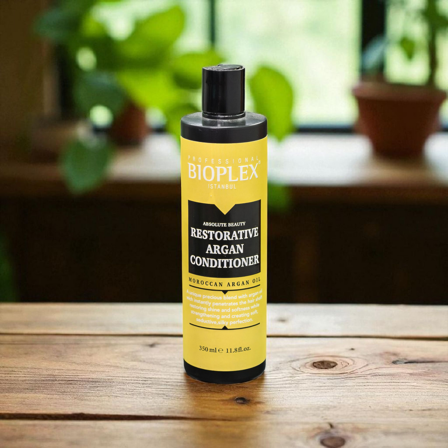 Bioplex Restorative Argan Conditioner bottle on a wooden surface with plants in the background