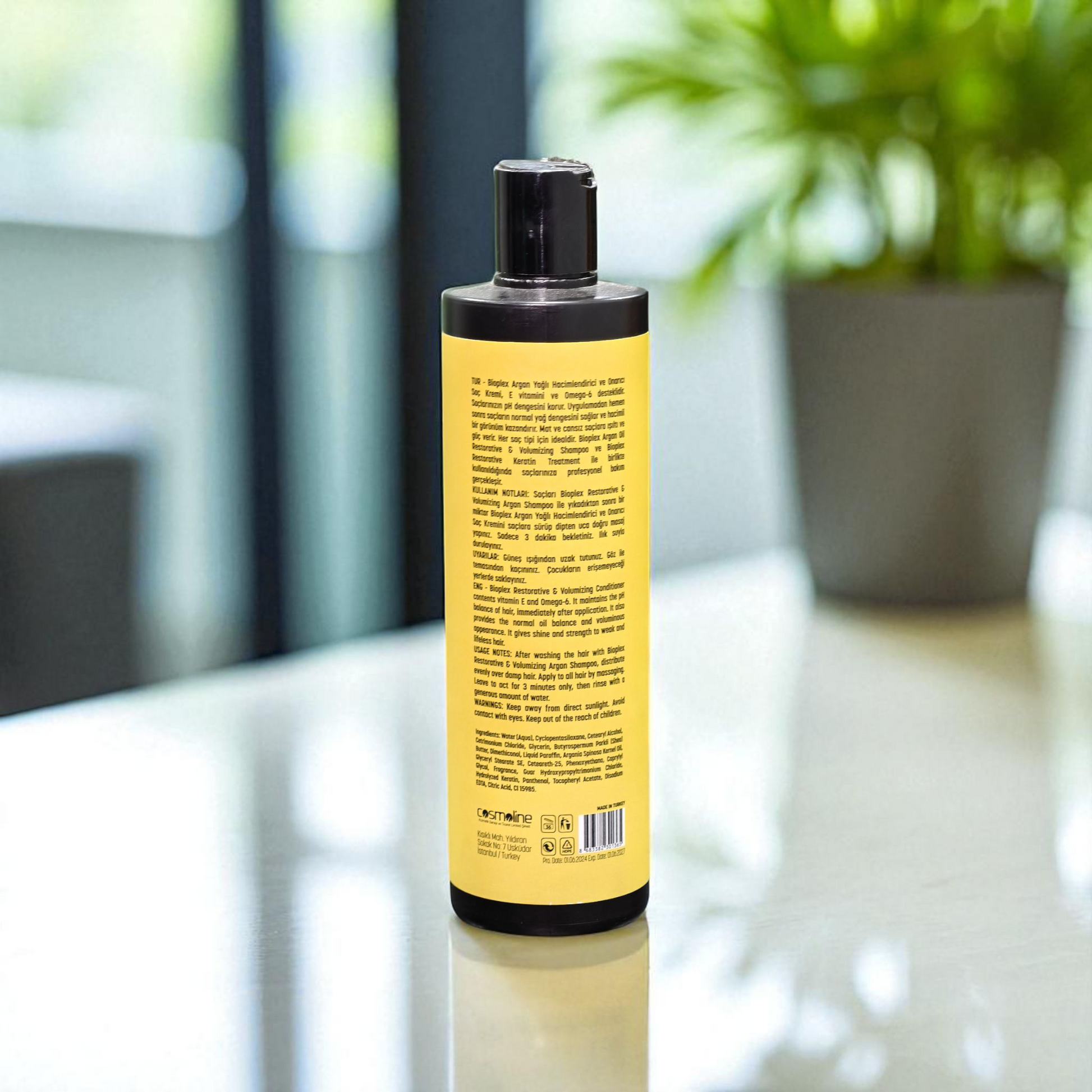 Shampoo bottle with yellow label on a reflective surface