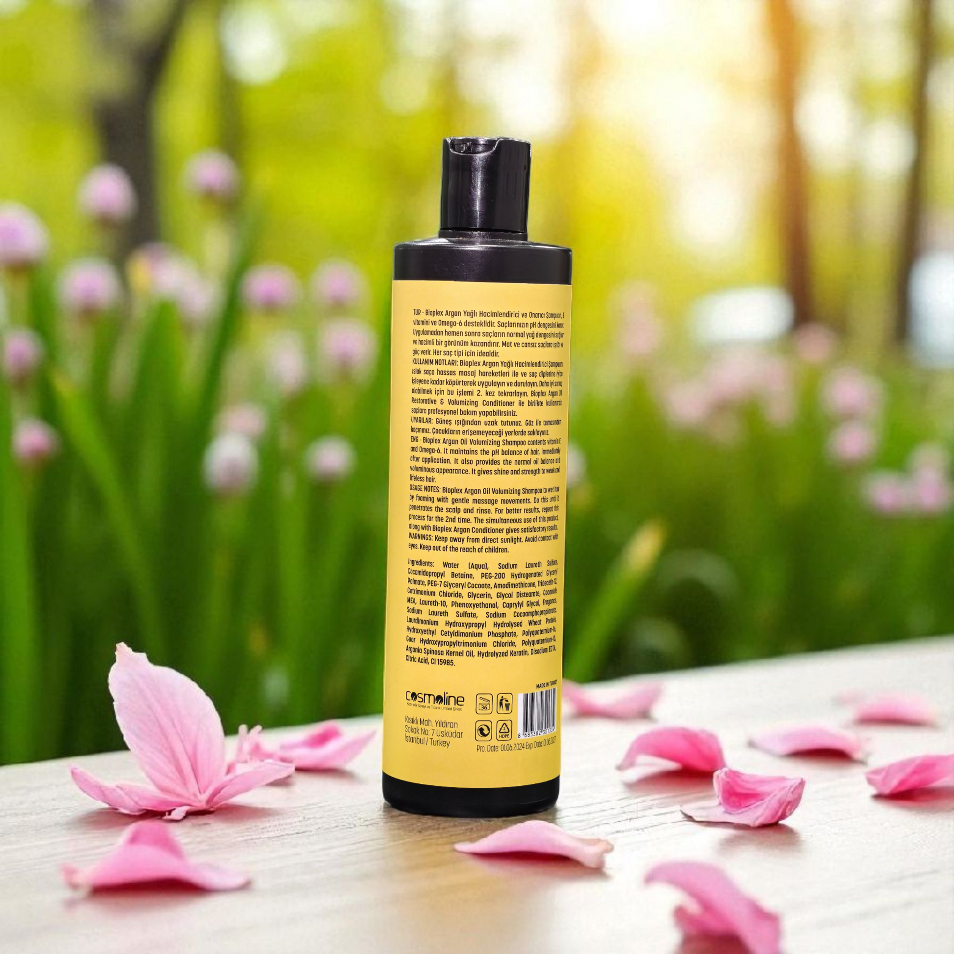 Shampoo bottle with a natural background of flowers and greenery